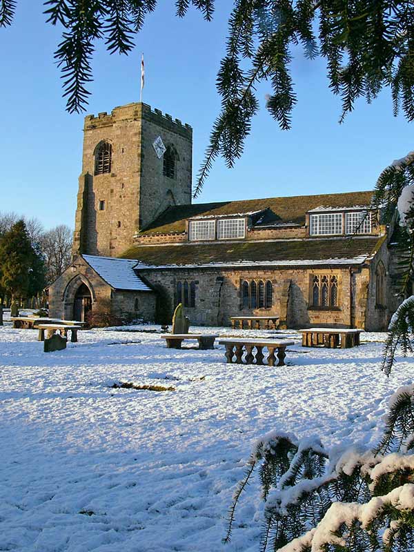 a church yard covered in snow